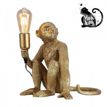 lámpara de mesa mono dorada